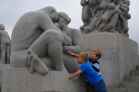 OSLO, NORWAY - AUG 09: Two children looking curiously at the statues in the Vigeland Park in Oslo, Norway on August 09, 2009.のeditorial素材