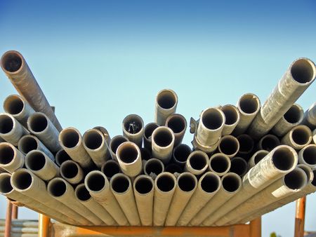 Scaffold poles on a rack set against a blue skyの写真素材