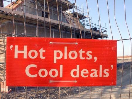 Sign on fence in front of new house constructionの写真素材