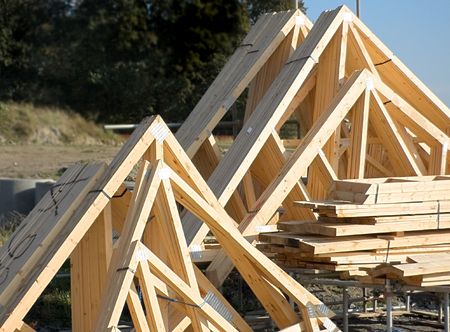 Wooden roof trusses stacked together on a building siteの写真素材