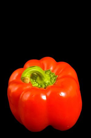 Single red Bell Pepper on a black backgroundの写真素材