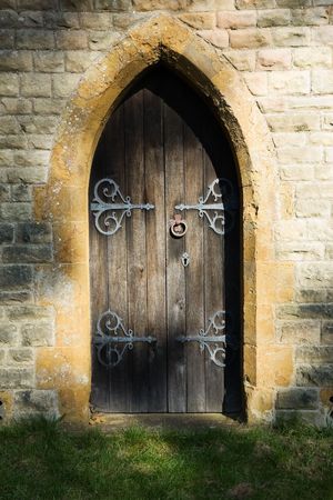 Mysterious semi-circular doorway dappled with a shadowy lightの写真素材