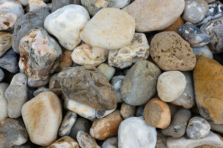 Multi-coloured stones and pebbles on a beachの写真素材