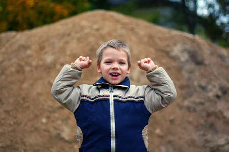 Little boy screaming and wave with his armsの写真素材