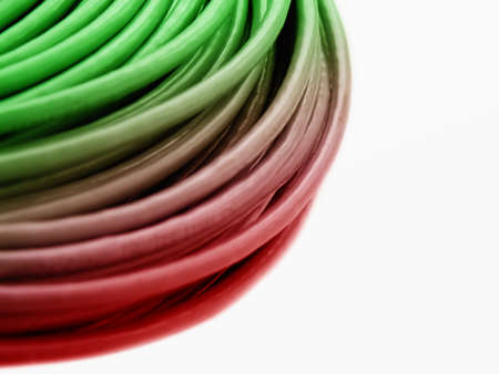 Hank of a green-red network cable on a white background