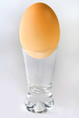 Egg in a wine-glass on a white backgroundの写真素材
