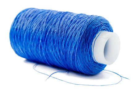 Roll of blue cotton threads isolated on a white background