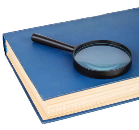 Magnifying glass on a blue book, isolated on white backgroundの写真素材