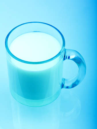 Blue toned glass of milkの写真素材