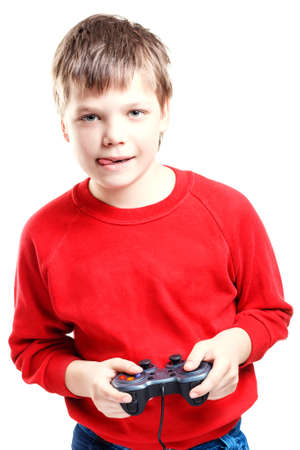 Cute boy with gamepad in hands is isolated on a white backgroundの写真素材