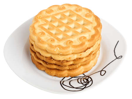 Stack of cookies on a white plate isolated on white backgroundの写真素材