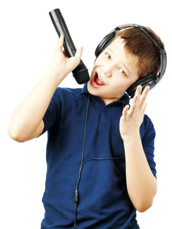 Teenage boy singing into a microphone and gesticulates with a hand on a whiteの写真素材