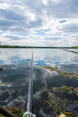 Fishing with a rod on a lake with a cloudy sky. High quality photo