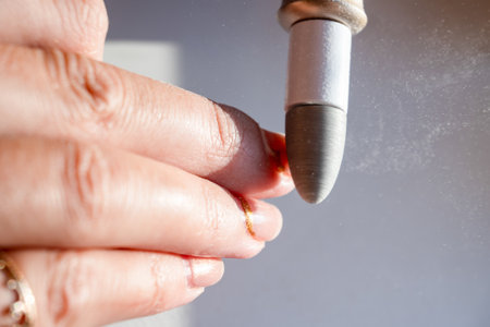 The process of removing varnish, old manicure with an electric machine at home. Lots of dust during removal. High quality photoの写真素材