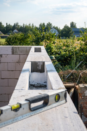 Building level. Horizontal level measurement. Building level on the surface of the wall. House construction. High quality photoの写真素材