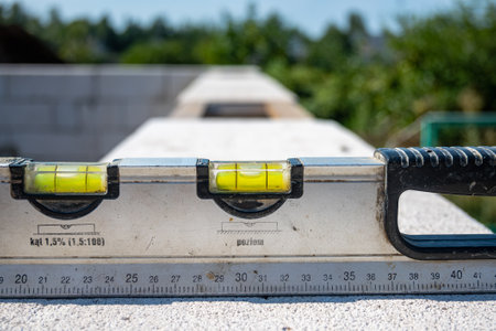 Building level. Horizontal level measurement. Wall laying by level. Building a house with your own hands. High quality photoの写真素材