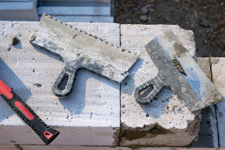 Working tool for laying aerated concrete blocks, spatula, trowel, rubber hammer. Construction of aerated concrete blocks, bricks. High quality photoの写真素材