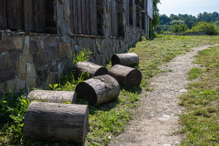 Tree logs lie along the fence, paths in the village. High quality photoの写真素材
