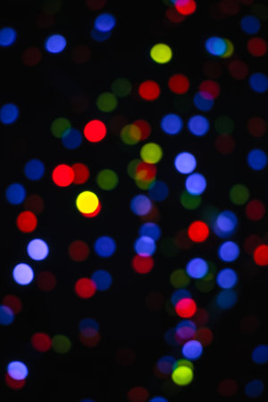 Abstract blurred colorful bokeh light.Blue, cyan, red, yellow, green blurred bokeh lights on a black...
