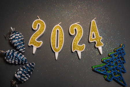 Beautiful Christmas background with the date 2024 on a gray background with sparkles and New Years...