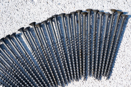 Black wood screws. Iron screws. Screws close-up on a white background. Wood fasteners