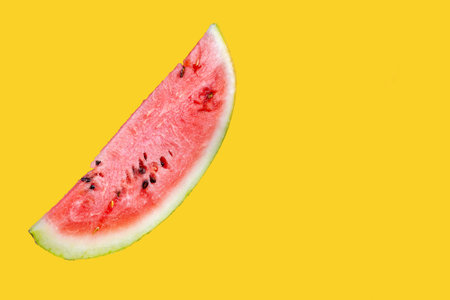 A piece of juicy watermelon on a jelly background. Watermelon slice isolated on yellow background. Ripe, juicy, full of vitamins watermelonの写真素材