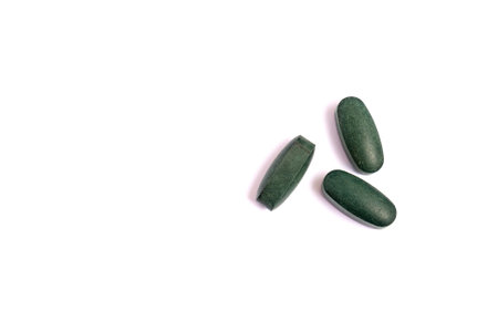 Green Pills isolated on white background. Medical drugs pills. Medical, healthcare, pharmaceuticals concept..の写真素材
