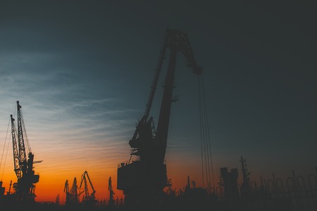 Colorful sunset over sea port and industrial