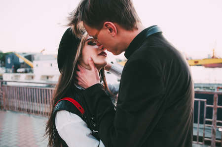 young couple kissing at sunset
