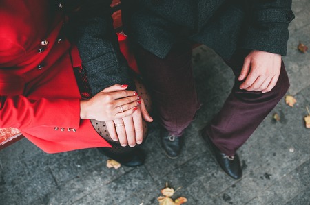 Beautiful, young couple is holding hands in nature.の写真素材