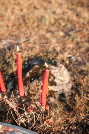 Red candles burn in nature during sunset. Romanceの写真素材