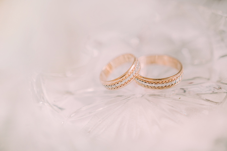 Preparing the girl for the wedding day. Details of the morning of the bride. Bouquet and rings, jewelry, printing. Light backgroundの写真素材