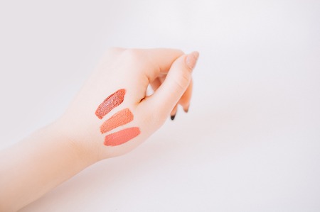 Samples of lipstick on the hand of a womanの写真素材