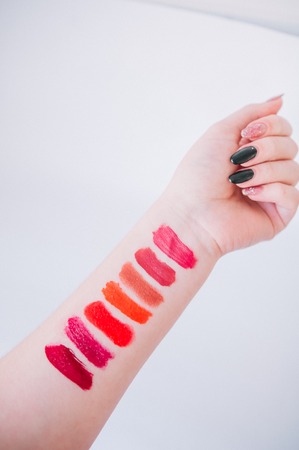 Lipstick makeup samples on female hand. Swatchの写真素材