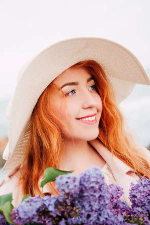 Girl with a bouquet of lilac on a white backgroundの写真素材
