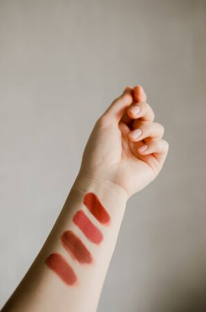Lipstick makeup swatches on female hand, flat layの写真素材