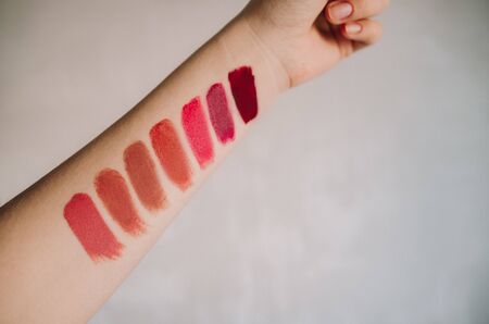 Swatch of bright lipsticks on the girl's hand, flat layの写真素材
