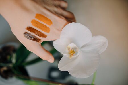 Swatch of bright lipsticks on the girl's hand, flat layの写真素材