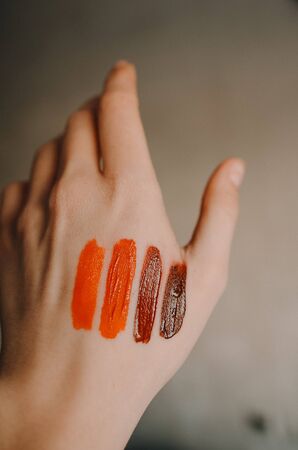 Swatch of bright lipsticks on the girl's hand, flat layの写真素材