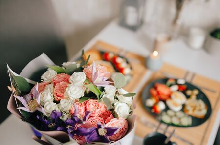 Beautiful homemade breakfast for two. Laid table with flowers and beautiful dishes. The concept of happiness and good nutrition.の写真素材