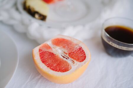 Fresh sliced grapefruit on a light backgroundの写真素材