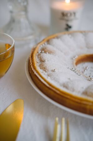 Delicious homemade cakes - pie on a white kitchen background with tea and golden appliancesの写真素材