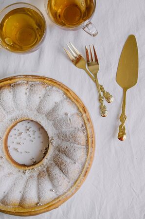 Delicious homemade cakes - pie on a white kitchen background with tea and golden appliancesの写真素材