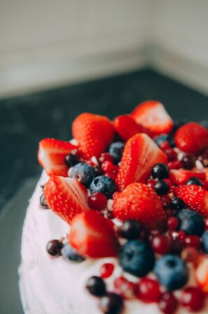 Delicious tart with fresh strawberries, raspberries and currants on the table. top view horizontalの写真素材