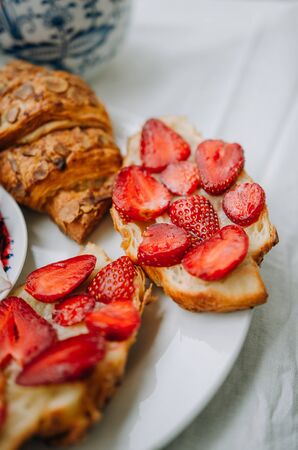 fresh croissants with jam and strawberry for breakfastの写真素材