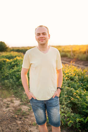 Young man at his grape plantation at sunset