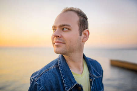 Portrait of a man at sunrise or sunset by the sea