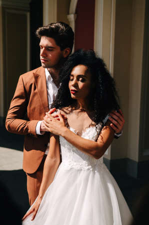 Beautiful African American girl in white dress with her husbandの写真素材