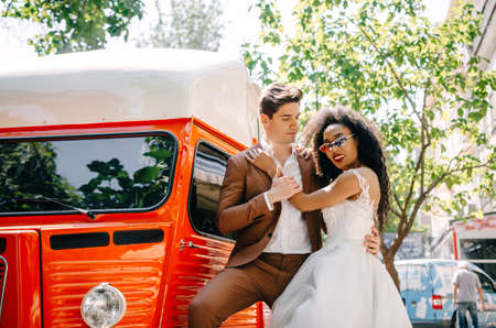 Beautiful African American girl in white dress with her husbandの写真素材