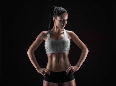 Young fitness woman showing her perfect sculpted muscular and tight bodyの写真素材